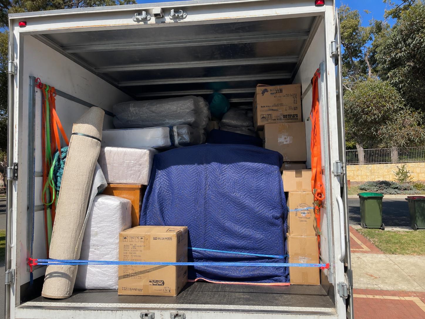 True West Removals crew with a fully wrapped and loaded truck